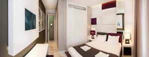 En eller flere senger på et rom på Eden Garden Suites