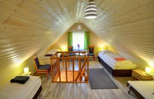 a large room with two beds and a table and chairs at Pensjonat Olympia w Przesiece in Przesieka
