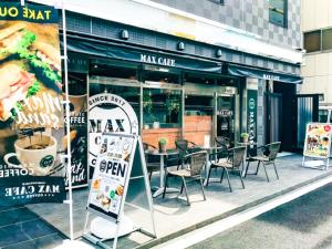 a restaurant with a table and chairs in front of it at HOTEL LiVEMAX Umeda WEST in Osaka
