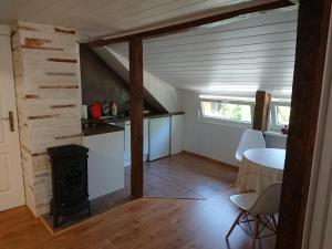 a kitchen with a stove and a table in a room at Large apartment with parking in Palanga