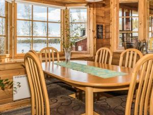 a dining room with a wooden table and chairs at Holiday Home Eden by Interhome in Kuusa