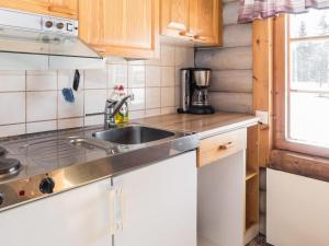 a kitchen with a sink and a counter top at Holiday Home Vuokatticottage f by Interhome in Vuokatti