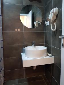La salle de bains est pourvue d'un lavabo et d'un miroir. dans l'établissement Apartment Dimeski, à Ohrid