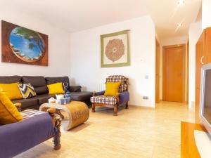 uma sala de estar com um sofá e uma cadeira em Holiday Home Cap Roig by Interhome em L'Ampolla