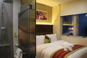 a bedroom with a bed and a television at Hotel Clover 5 HongKong Street (SG Clean) in Singapore
