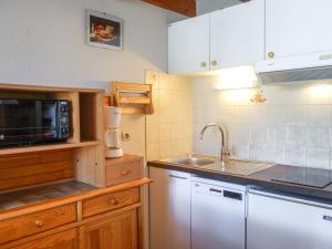 a kitchen with a sink and a microwave at Holiday Home La Coralline-3 by Interhome in Vaux-sur-Mer