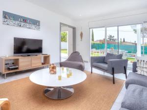 a living room with a tv and a table at Holiday Home Almendro by Interhome in Santa Cristina d'Aro