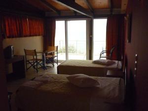 Postel nebo postele na pokoji v ubytování Hotel Dimitra