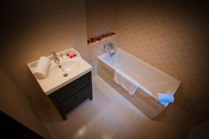 ブラショヴにあるDrumul Poienii Apartmentの洗面台と浴槽のあるバスルーム +28枚の写真