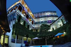 a large building with a tree in front of it at Hotel Nata in Tbilisi City