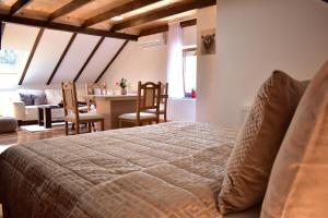 a bedroom with a bed and a dining room at Plitvice Panta Rei in Plitvička Jezera