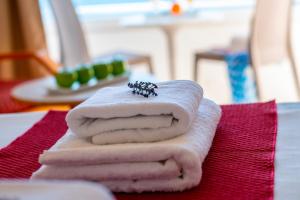 a pile of towels sitting on top of a table at Queens Bay Hotel in Paphos