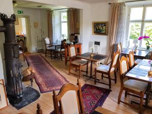 a living room with a fireplace and a table and chairs at Stora Herrestad B&B in Ystad