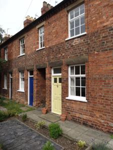 a brick building with a yellow door and windows at 22 Mill Road in Lincoln