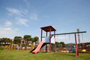 a playground with a slide in a park at Hotel Residence Key Club in Montalto di Castro