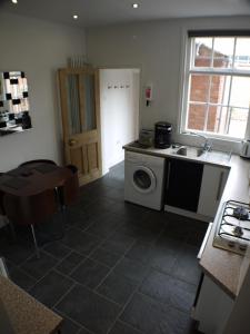 a kitchen with a sink and a washing machine at 22 Mill Road in Lincoln