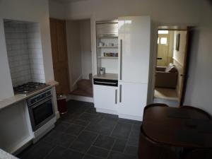 a kitchen with a stove and a refrigerator at 22 Mill Road in Lincoln