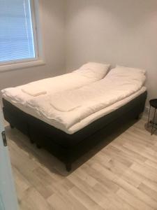 a bed sitting in a corner of a room at Soda Home - Karlsro, 24 h check in in Närpiö +15 photos