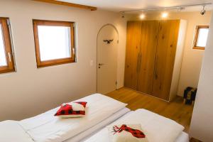 a bedroom with a white bed with two pillows on it at Casa Jacuzzi in Arosa