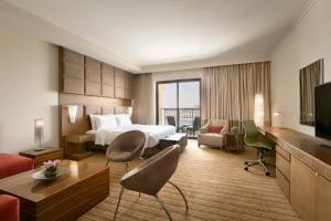 a hotel room with a bed and a television at Traders Hotel, Abu Dhabi in Abu Dhabi