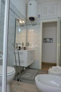a bathroom with a white toilet and a sink at Your Home at Rome in Rome