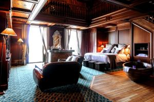 a bedroom with a bed and a couch and a chair at Le Palace de Menthon in Menthon-Saint-Bernard +69 photos