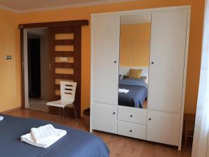 a bedroom with a bed and a large white cabinet at Chillout in Stargard