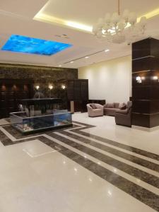 a living room with a couch and a table at Big Ben Hotel Suites in Amman