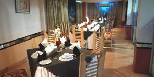 a long row of tables in a restaurant at Hotel Dallas Sylhet in Sylhet