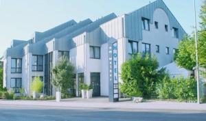 a large building on the side of a street at Hotel am Weiher in Erkelenz