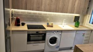 a kitchen with a sink and a washing machine at MUSU in Estella