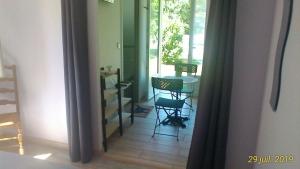 a hallway with a table and chairs in a room at Le Clos des Palombes in Saint-Pierre-du-Mont