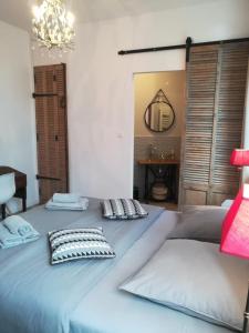 a large blue bed with two pillows on it at Villa Colonna Appartements in Manosque