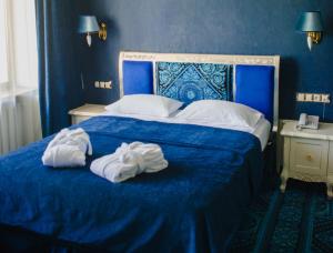 Postel nebo postele na pokoji v ubytování Olympic Hotel