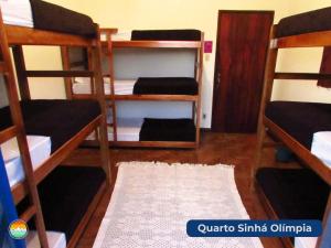 a room with four bunk beds with a rug at Buena Vista Hostel in Ouro Preto