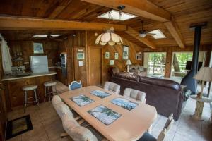 a living room with a table and a couch at Riverfront Treetop Bungalow in Homosassa