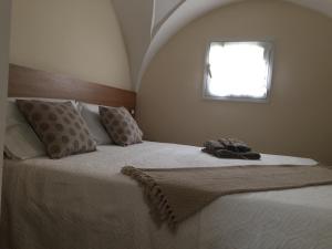a bedroom with a large bed with a window at VIA DANTE LUXURY in Matino