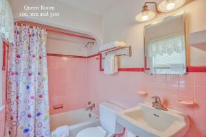a pink bathroom with a sink and a toilet at King Charles Hotel in Ocean City +56 photos