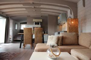 a living room with a couch and a table at Comme un Poisson dans l'Eau in Villennes-sur-Seine