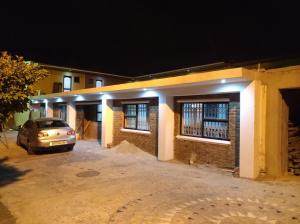 a car parked in front of a building at night at Liziwe's Guest House in Matroosfontein