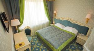 Postel nebo postele na pokoji v ubytování Olympic Hotel