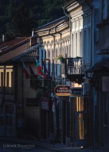 a building with flags on the side of it at Tarnava - Oldtown House in Veliko Tŭrnovo