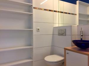 a white bathroom with a toilet and a sink at North Sea Cottage Middelkerke in Middelkerke +29 photos