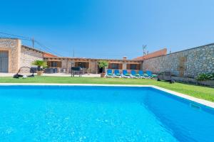 a villa with a swimming pool and a yard at Sestados in Sa Pobla