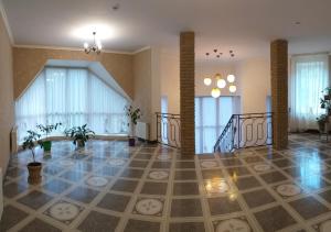 a living room with a staircase and a lobby at Hotel Aragvi in Cherkasy