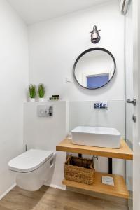 a bathroom with a sink and a mirror at Blubini Heritage House in Rovinj +26 photos