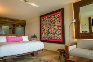 a living room with a painting on the wall at Hotel Xcaret Mexico All Parks All Fun Inclusive in Playa del Carmen