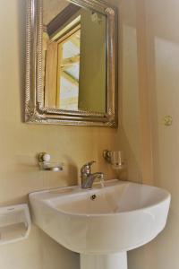 a white sink in a bathroom with a mirror at Hiwang Native House Inn & Viewdeck in Banaue