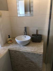 a bathroom with a sink and a mirror at Saracen Head Hotel in Beith