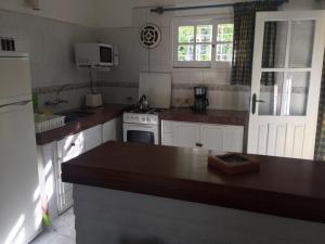 a kitchen with white appliances and a counter top at Casa Azul in Maldonado